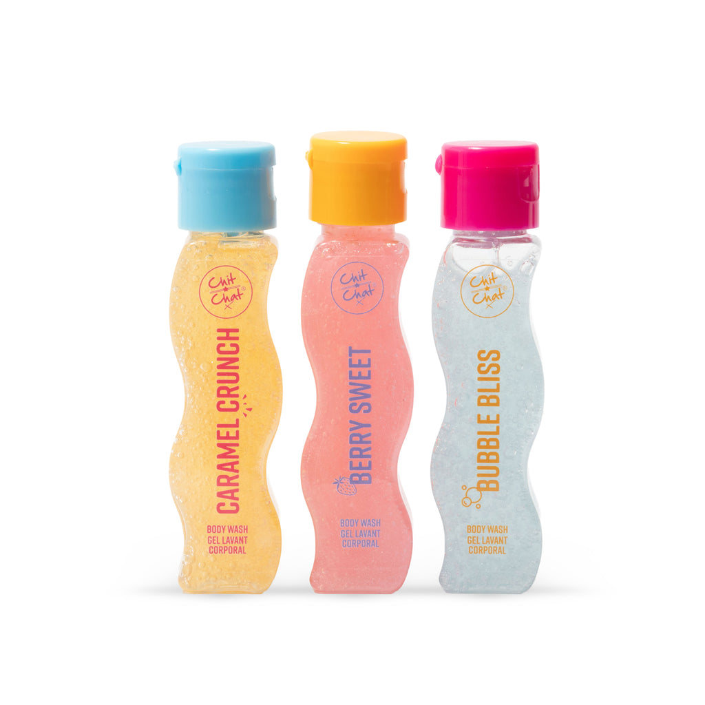 Three wavy plastic clear body wash bottles from the brand Chit Chat, shown side-by-side on a white background. From left to right, the bottles are labelled 'Caramel Crunch' with a light blue cap, 'Berry Sweet' with a yellow-orange cap, and 'Bubble Bliss' with a hot pink cap.
