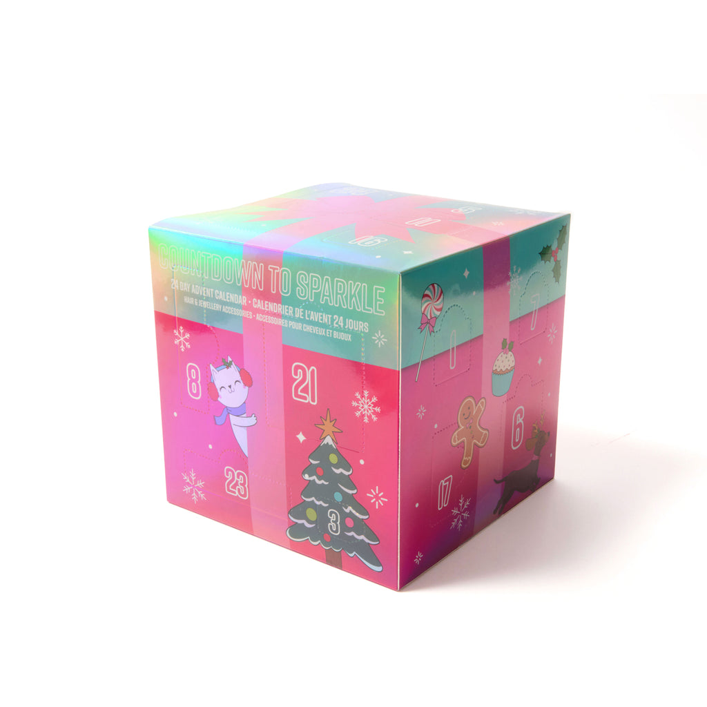 A colourful advent calendar box with illustrated holiday scenes and numbered compartments, photographed on a clean white background.